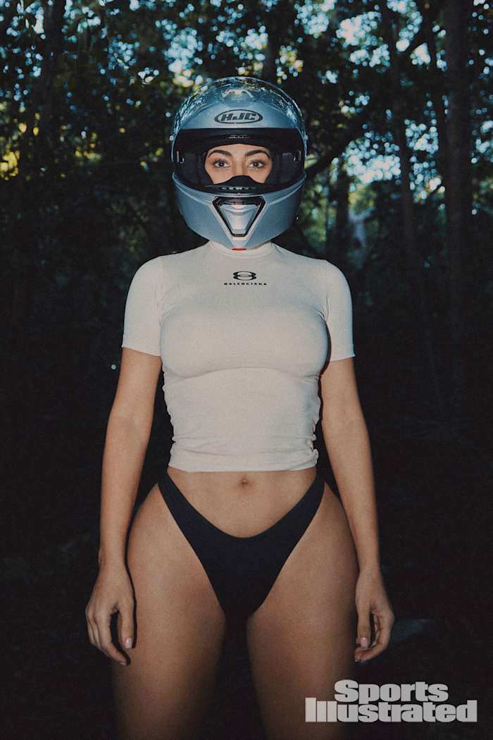 Kim Kardashian was photographed by Greg Swales in the Dominican Republic. Swimsuit by SKIMS. Top by Balenciaga. Helmet by HJC.
